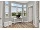 Bright office space with multiple windows, a modern desk, and stylish wood-look tile flooring at 13112 Luntz Point Ln, Windermere, FL 34786