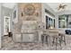 Well-equipped outdoor kitchen featuring modern grill, granite countertops, and bar seating at 13112 Luntz Point Ln, Windermere, FL 34786