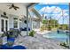 A screened-in patio and pool with a beautiful view of the backyard landscape at 13112 Luntz Point Ln, Windermere, FL 34786