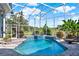 Stunning view of the screened-in pool with lush landscaping and clear blue skies at 13112 Luntz Point Ln, Windermere, FL 34786