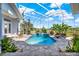 Beautiful screened-in pool area, complete with a sunning lounge area and lush greenery at 13112 Luntz Point Ln, Windermere, FL 34786