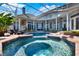 Relaxing pool with hot tub and backyard featuring an outdoor kitchen for entertaining at 13112 Luntz Point Ln, Windermere, FL 34786
