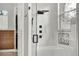 Elegant shower design features a glass door, pebble floor detail, and full wall of luxurious tile at 13112 Luntz Point Ln, Windermere, FL 34786
