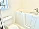 Bathroom featuring safety tub and toilet at 1312 Corona Ave, The Villages, FL 32159