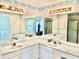 Bathroom featuring a white double sink vanity with mirror and lighting at 1312 Corona Ave, The Villages, FL 32159