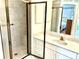 Bathroom featuring a glass shower, and marble countertop vanity at 1312 Corona Ave, The Villages, FL 32159