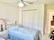 Cozy bedroom featuring a twin bed, neutral walls, and a closet for storage at 1312 Corona Ave, The Villages, FL 32159