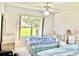Cozy bedroom with two twin beds, a large window offering natural light, and neutral walls at 1312 Corona Ave, The Villages, FL 32159