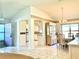 View of dining room with chandelier lighting, china cabinet, and views into kitchen and entryway at 1312 Corona Ave, The Villages, FL 32159