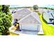 Well-maintained single-story home featuring a two-car garage, brick pavers, and lush landscaping at 1312 Corona Ave, The Villages, FL 32159