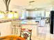 Bright kitchen featuring white cabinetry, granite countertops, an island, and stainless appliances at 1312 Corona Ave, The Villages, FL 32159