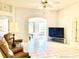 Inviting living room with tile flooring, neutral paint, and arched doorways, perfect for relaxing and entertaining at 1312 Corona Ave, The Villages, FL 32159