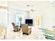 Spacious living room with tile flooring, glass coffee tables, ceiling fan and ample natural light at 1312 Corona Ave, The Villages, FL 32159