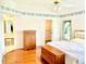 Main bedroom with wood floors, floral wallpaper and a walk-in closet at 1312 Corona Ave, The Villages, FL 32159