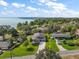 Aerial view showing the home, landscaping, and its proximity to the lake with beautiful surrounding greenery at 137 E Palmetto Ave, Howey In The Hills, FL 34737