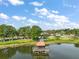 Lake view showcasing a covered pier at 137 E Palmetto Ave, Howey In The Hills, FL 34737