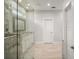 Bathroom featuring a glass shower door, tile floors, white cabinets, and a mirror at 137 E Palmetto Ave, Howey In The Hills, FL 34737