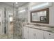 Bathroom featuring a glass shower door, marble countertops, white cabinets, and a mirror at 137 E Palmetto Ave, Howey In The Hills, FL 34737