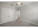 Bedroom with carpet, ceiling fan, large closet, and neutral paint at 137 E Palmetto Ave, Howey In The Hills, FL 34737
