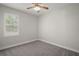 Bedroom with carpet flooring, a ceiling fan, and a bright window at 137 E Palmetto Ave, Howey In The Hills, FL 34737