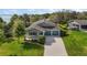 Beautiful single-Gathering home with a well-manicured lawn, two-car garage, and a view of the lake at 137 E Palmetto Ave, Howey In The Hills, FL 34737