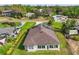 Aerial view showcasing a solar-paneled roof and lush green lawn at 137 E Palmetto Ave, Howey In The Hills, FL 34737
