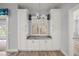 Bright kitchen with cabinetry, granite countertops, a window, and a chandelier at 137 E Palmetto Ave, Howey In The Hills, FL 34737