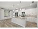 Bright, white kitchen with granite countertops, stainless appliances, and a central island at 137 E Palmetto Ave, Howey In The Hills, FL 34737
