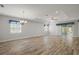 Spacious living room with ample natural light, wood-look floors, and modern ceiling fixtures at 137 E Palmetto Ave, Howey In The Hills, FL 34737