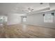 Expansive living area featuring modern ceiling fan, recessed lighting, and wood-look flooring at 137 E Palmetto Ave, Howey In The Hills, FL 34737
