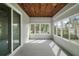 Enclosed patio boasting a wood ceiling, multiple windows, and ample natural light with view of the back yard at 137 E Palmetto Ave, Howey In The Hills, FL 34737