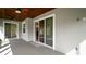 Covered patio featuring a wood ceiling, multiple windows, and providing access to the home's interior at 137 E Palmetto Ave, Howey In The Hills, FL 34737