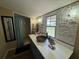 Bathroom featuring decorative stone wall accents, modern sink, and walk-in shower at 1425 Douglas Rd, Groveland, FL 34736