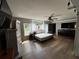 Bedroom with hardwood floors, a ceiling fan, and bright windows offering plenty of natural light at 1425 Douglas Rd, Groveland, FL 34736