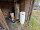 Well equipment including holding tanks, water pump and filters on the exterior of the property at 1425 Douglas Rd, Groveland, FL 34736