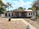 Charming single-story home with a welcoming front porch and landscaped front yard at 1425 Douglas Rd, Groveland, FL 34736