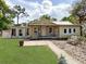 Charming single-story home with a welcoming front porch and landscaped front yard at 1425 Douglas Rd, Groveland, FL 34736