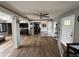 Spacious living room with hardwood floors, neutral tones, and a ceiling fan at 1425 Douglas Rd, Groveland, FL 34736