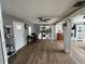 Open-concept living room featuring beautiful hardwood floors, ceiling fan, and ample natural light at 1425 Douglas Rd, Groveland, FL 34736