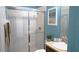 Clean bathroom with white tiled shower and decorative elements at 146 Essex Pl, Davenport, FL 33896