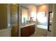 Bright bathroom featuring double sinks, shower, soaking tub and warm neutral tones at 146 Essex Pl, Davenport, FL 33896