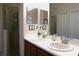 Bathroom featuring double sinks, granite countertops, and a glass-enclosed shower at 146 Essex Pl, Davenport, FL 33896