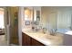 Bathroom with double sinks, shower, and closet for ample storage space at 146 Essex Pl, Davenport, FL 33896