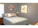 Cozy bedroom with decorative floral artwork and soft, ambient lighting at 146 Essex Pl, Davenport, FL 33896