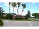 Beautiful community entrance sign, “The Shire,” surrounded by mature landscaping and elegant brickwork at 146 Essex Pl, Davenport, FL 33896