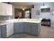 Spacious kitchen with sleek countertops, a dishwasher, and a view of the living room at 146 Essex Pl, Davenport, FL 33896