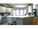 Open-concept kitchen with a breakfast bar, white cabinets, stainless steel appliances, and eat-in area at 146 Essex Pl, Davenport, FL 33896