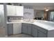 Spacious kitchen featuring white cabinets, gray lower cabinets, and stainless steel appliances at 146 Essex Pl, Davenport, FL 33896