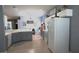 Open kitchen with white appliances, gray cabinets, tile flooring, and an eat-in breakfast area at 146 Essex Pl, Davenport, FL 33896