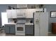 Well-equipped kitchen featuring white cabinets, modern appliances, and ample counter space for cooking at 146 Essex Pl, Davenport, FL 33896